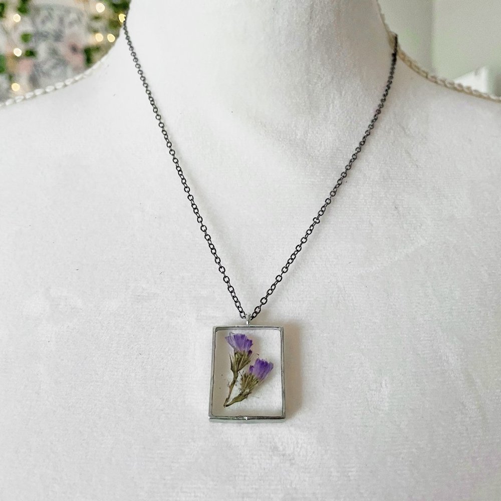 Purple floral botanical flower resin necklace in dark silver bezel